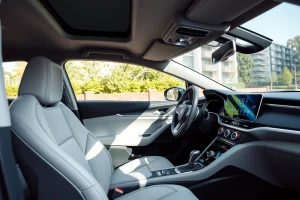A modern, ergonomic car interior with intuitive dashboard layout, comfortable driver seat, touchscreen infotainment system, steering wheel with multifunction controls, ambient lighting, and clear visibility through the windshield — designed for functionality and thoughtful ergonomics for every driver, realistic lighting, high detail
