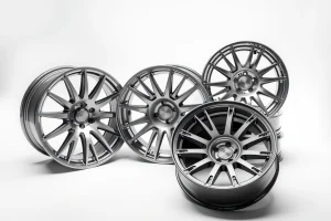 A set of lightweight and durable car wheels made of alloy, displayed on a clean white background with soft lighting, showing intricate spoke design and metallic finish, emphasizing strength and modern engineering